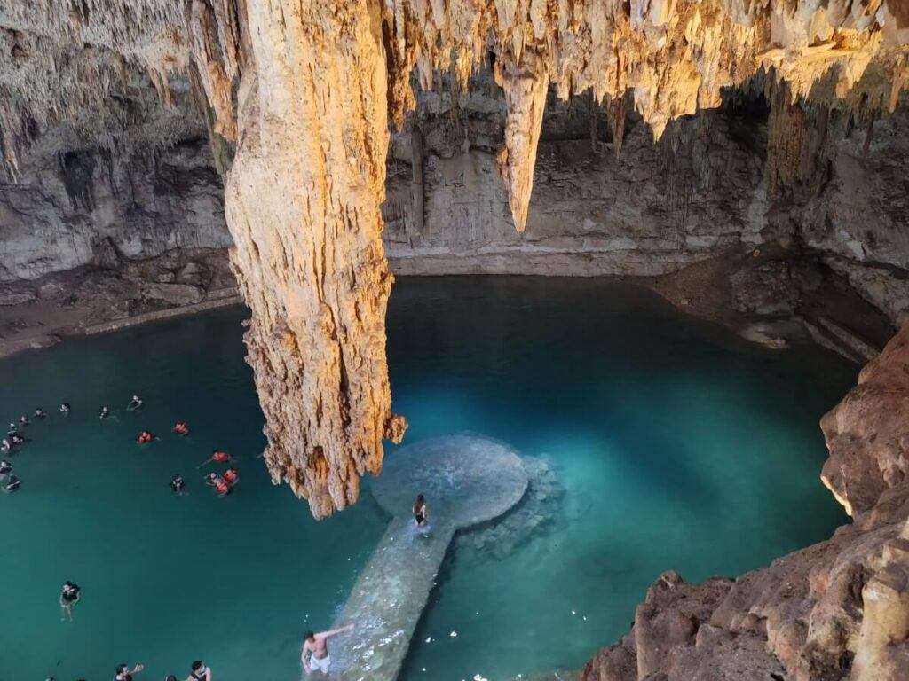 A cave filled with turquoise water.