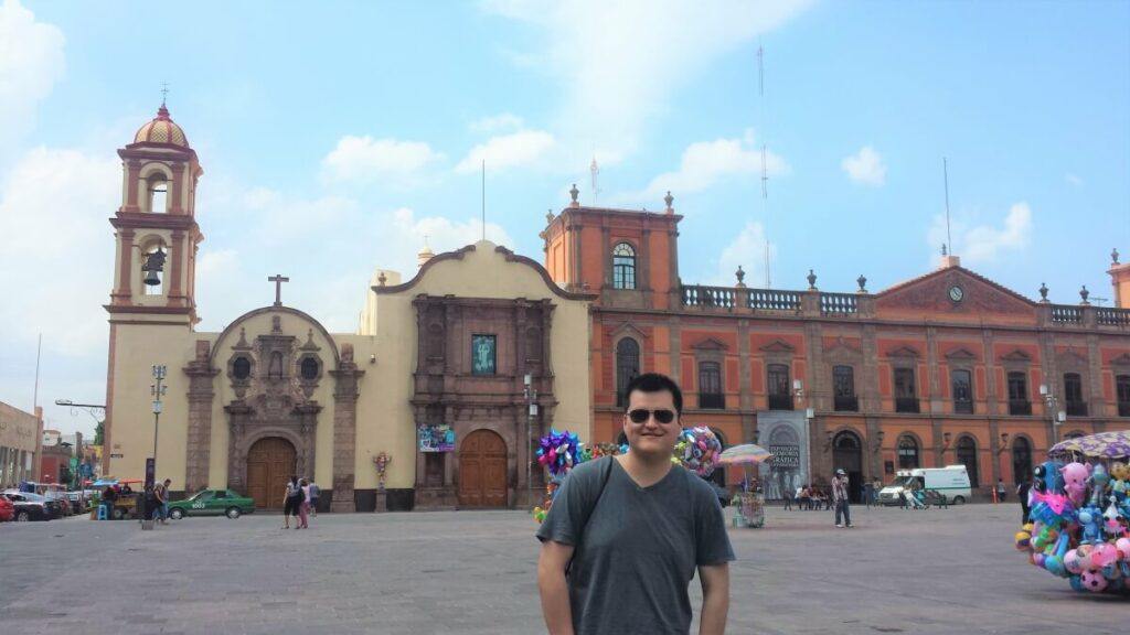 Young man in front of old buildings in San Luis Potosi.