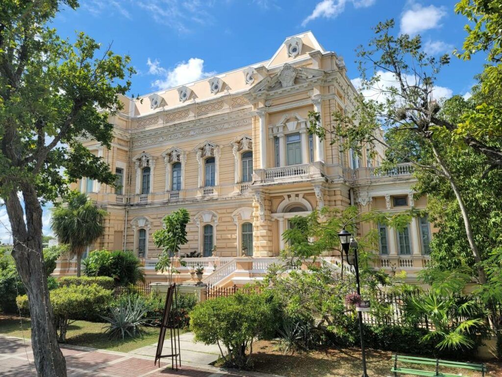 A tan mansion with French architecture.