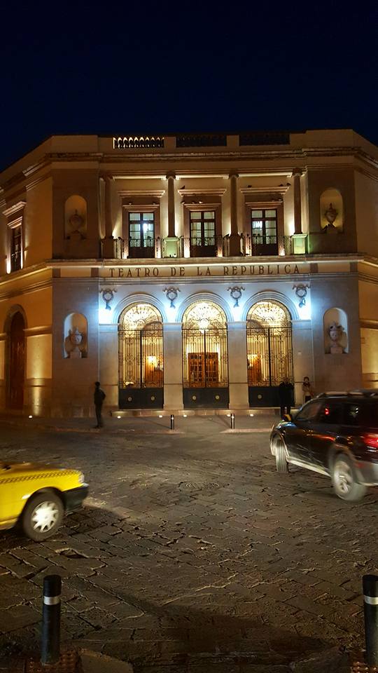 A theater lit up at night.