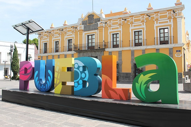 Yellow building with the words Puebla at the front.