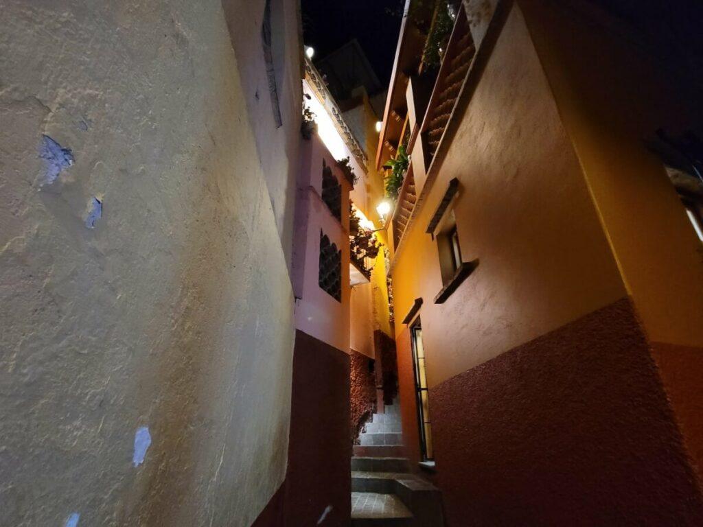 An alley lit up at night.