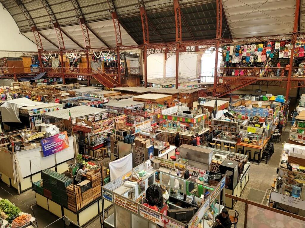Interior of a market filled with stalls.