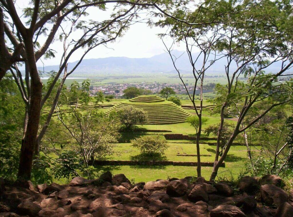 Circular pyramid in the center surrounded by lots of vegetation.