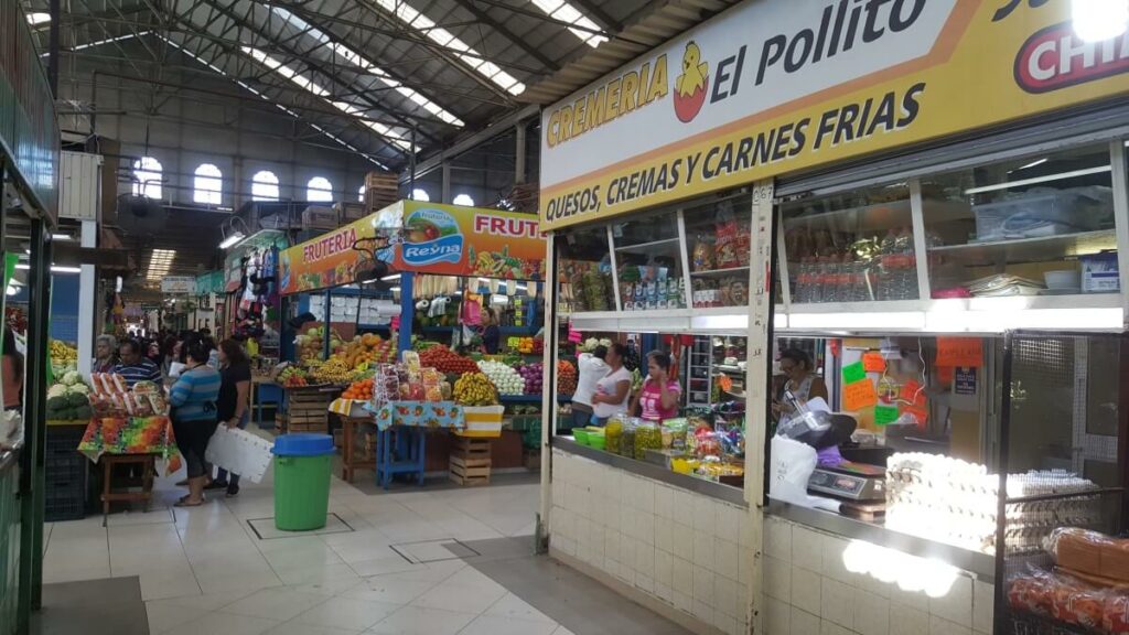 Interior of a local Mexican market with fruits and vegetables on display.