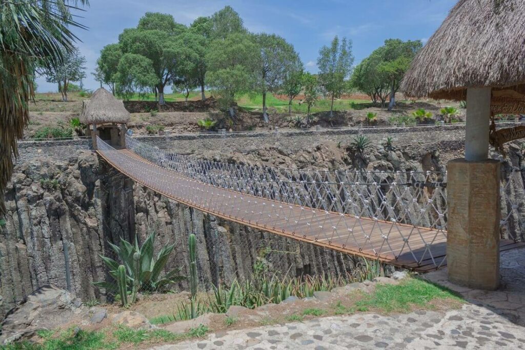 Basalt formations with a suspended bridge in the middle.