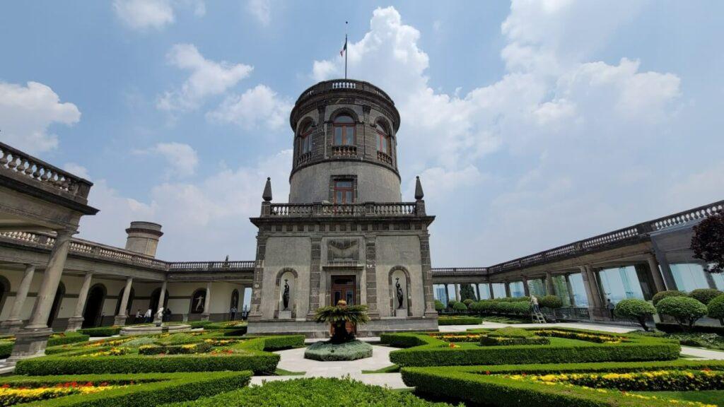 A tower and a garden at a castle.