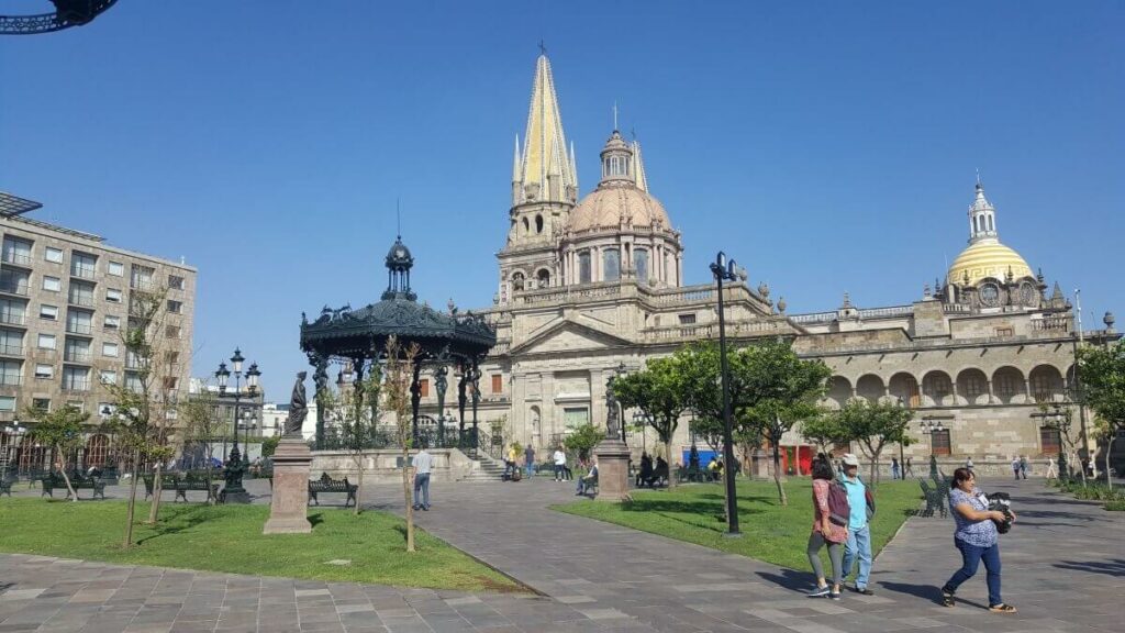 Guadalajara main square with a kiosk in the center and the cathedral in the background.