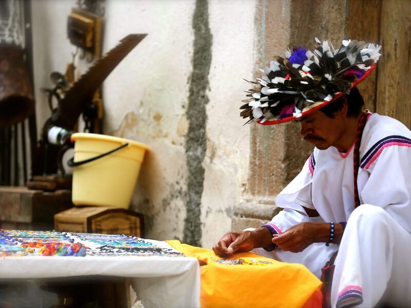Huichol man sending handmade jewelry.