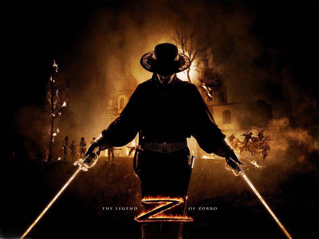 Zorro holding two swords and fire behind him.
