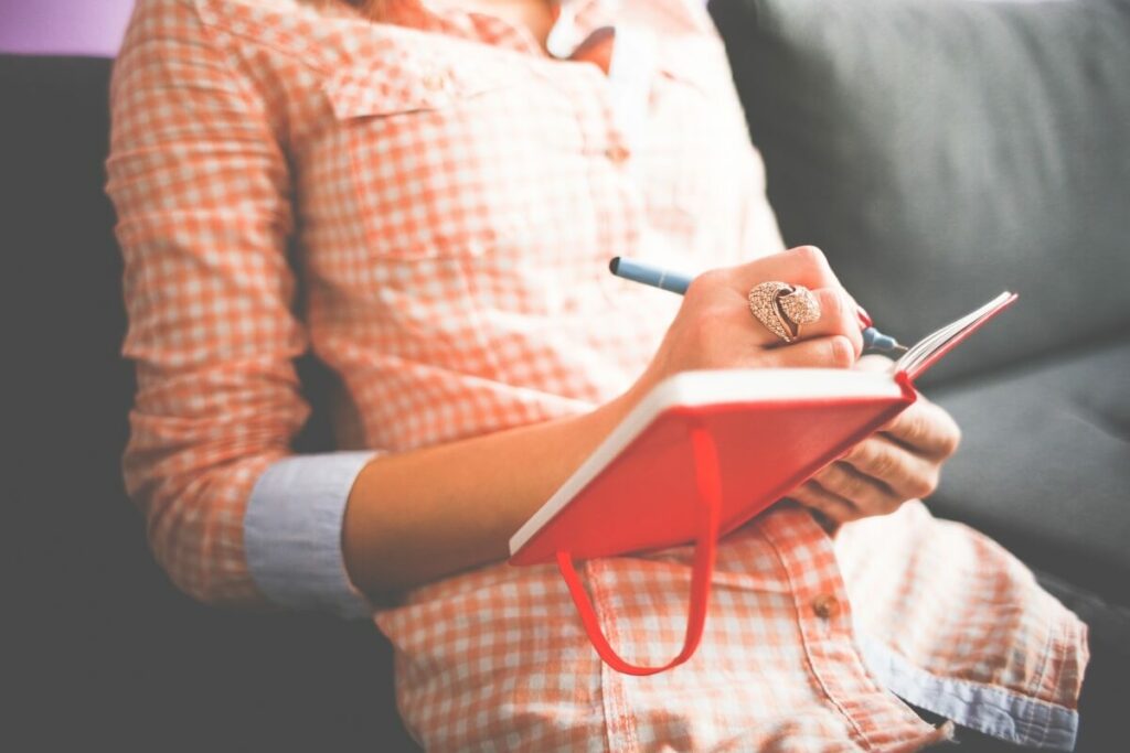 Woman writing in a notebook.