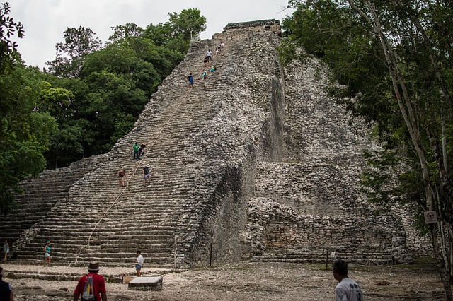 People climbing a pyramid in Coba, Mexico.