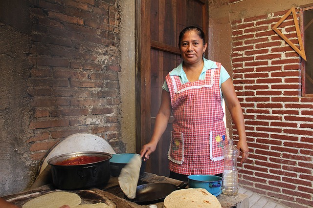 Traditional Mexican cook making tortillas.