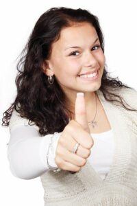 Young woman giving a thumbs up.