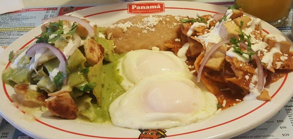 Red and green chilaquiles with beans and eggs.