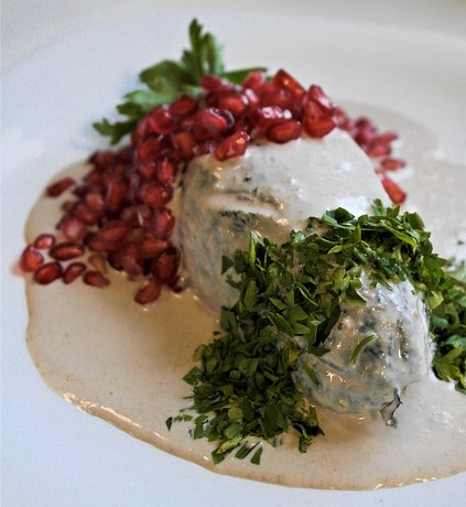 Chile en nogada with pomegranate and parsley.