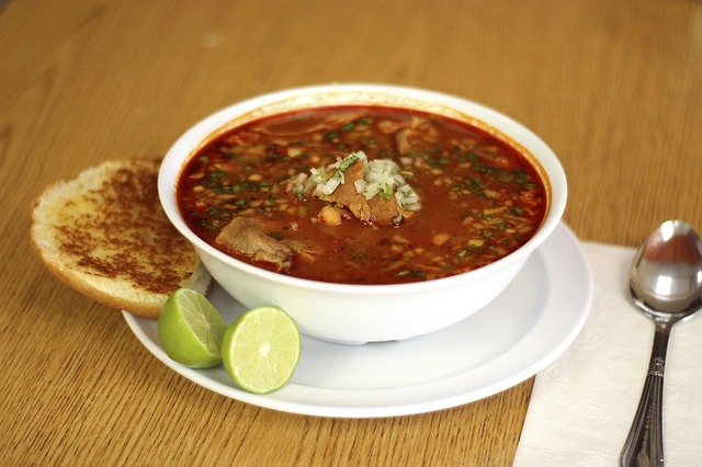 A bowl of red pozole.