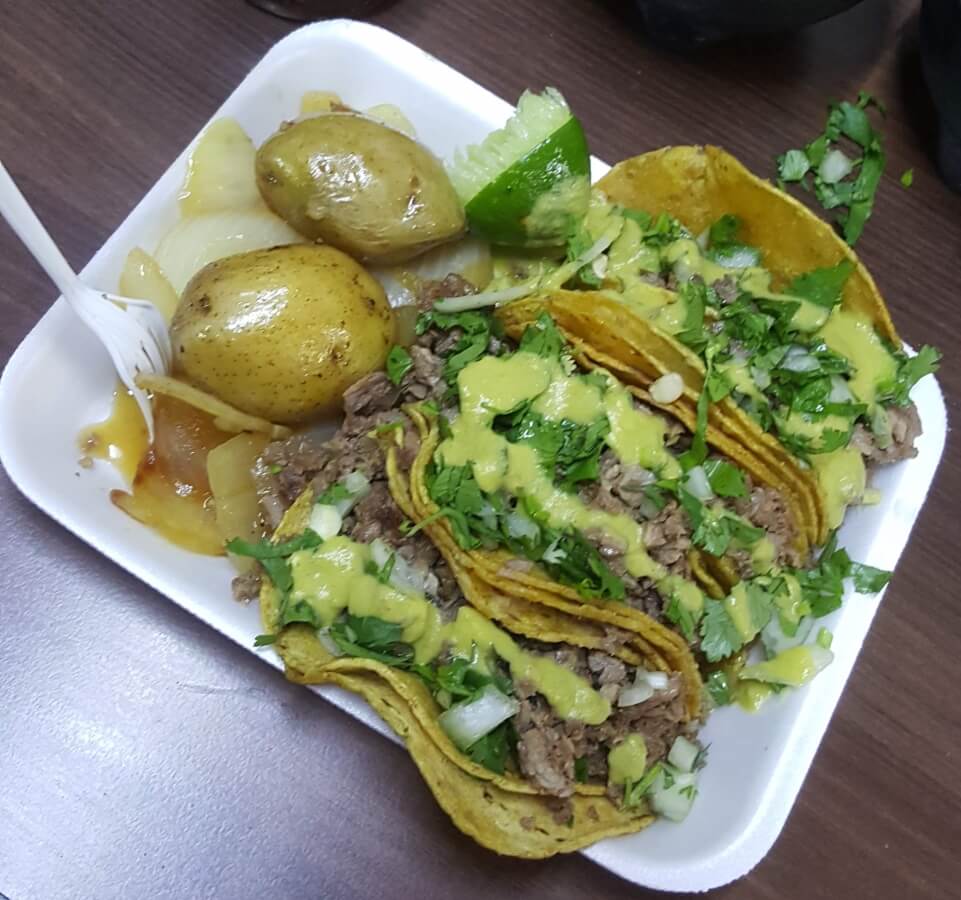 Bistec tacos with cilantro, onion, lime, potateoes, and salsa.