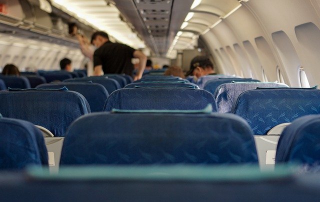 Several people inside an airplane cabin.