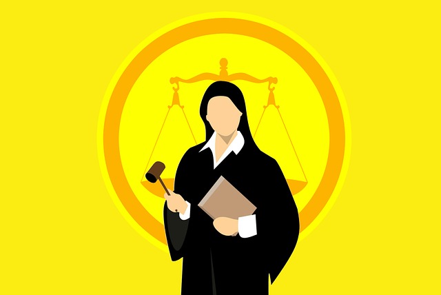 A female judge dressed in black and holding a gavel in her hand.