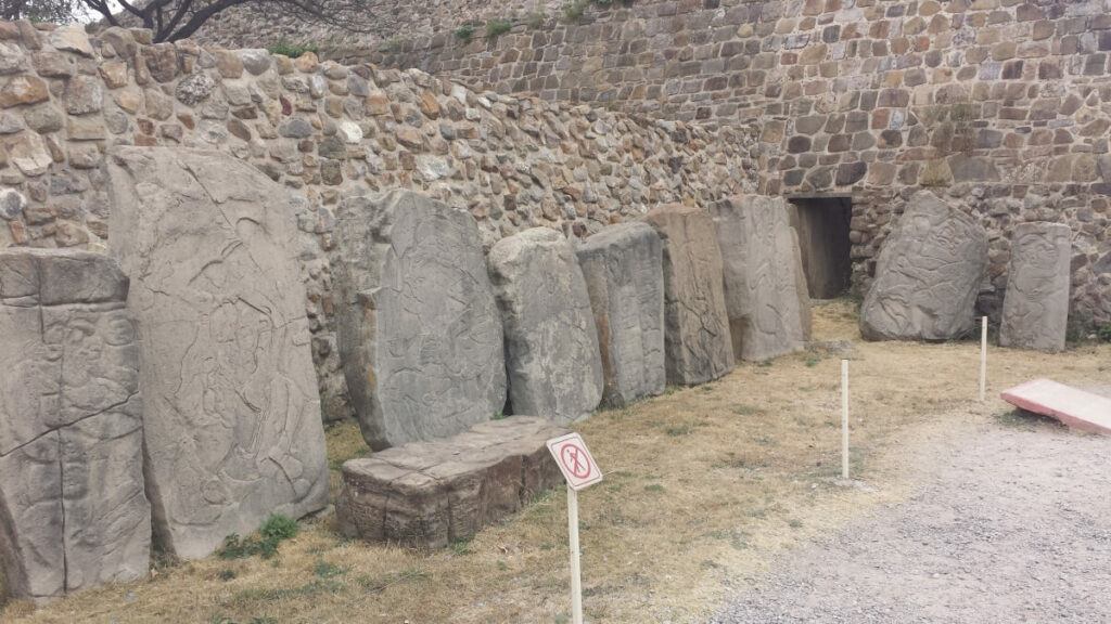 Various steles and the entrance to an ancient tomb.