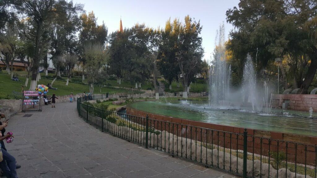 Park with a fountain in the middle.