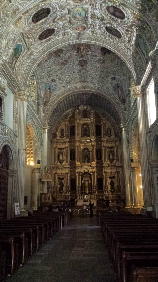 Golden altar with saints inside a church.