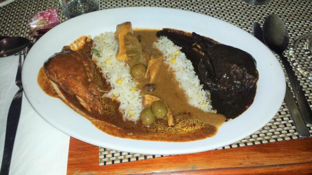 Three different kinds of mole with chicken and rice.