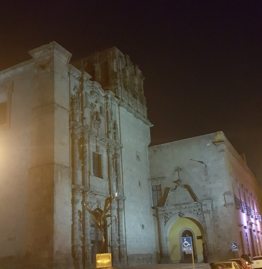 Old church lit up at night.