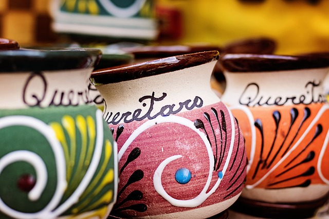 Three colorful pottery cups with the word Queretaro on them.