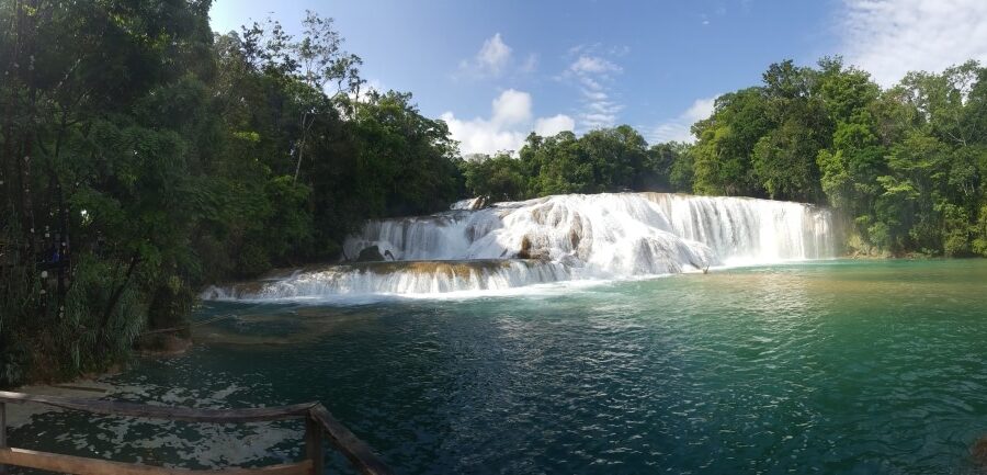 A waterfall with turquoise water below it.