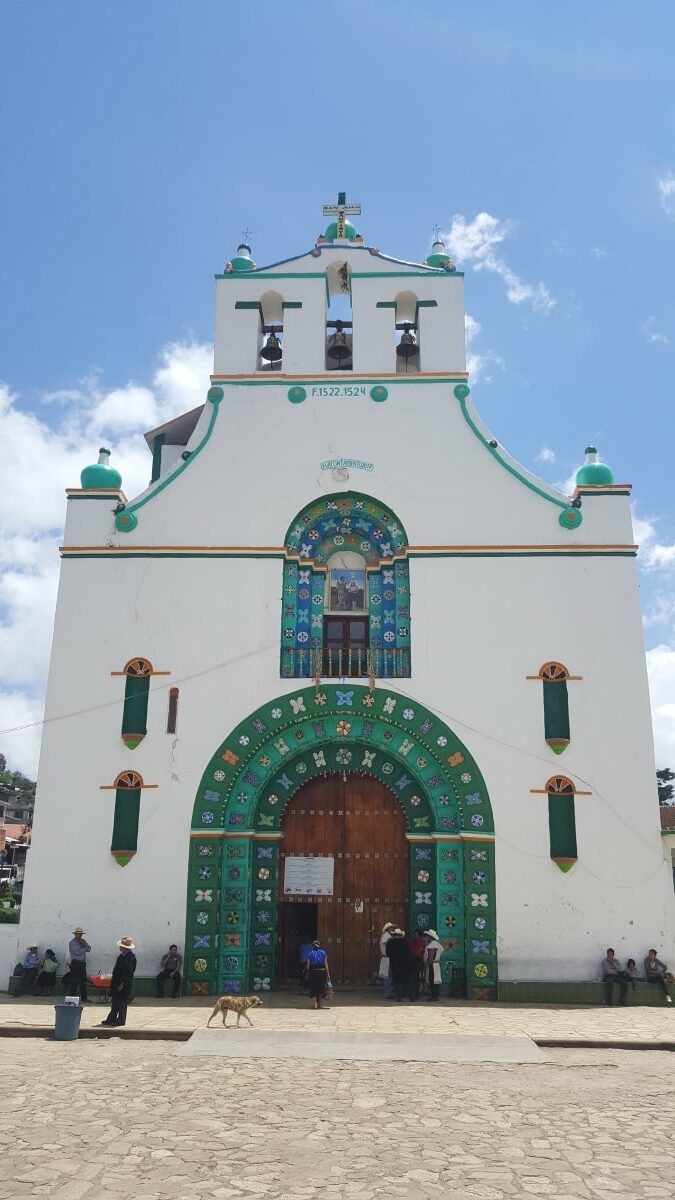 A white church with green decorations.