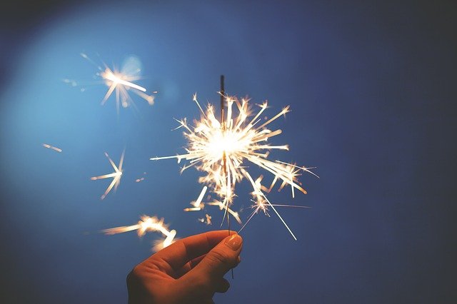 A hand holding a sparkler.