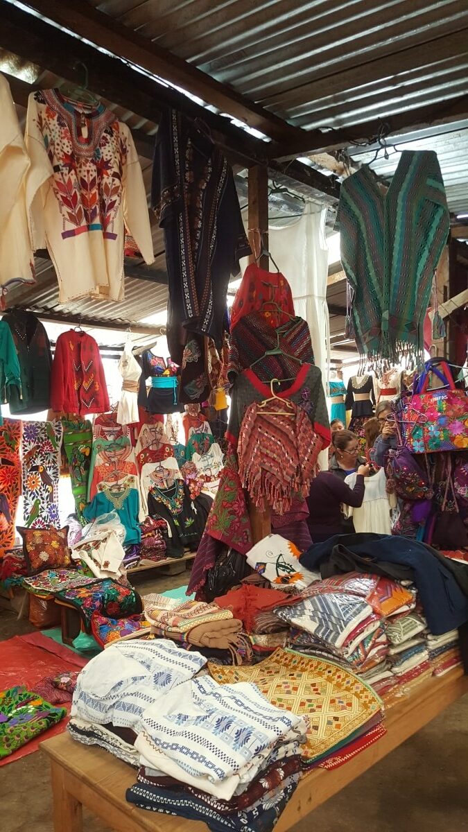 Lots of colorful clothes made by hand at a local market.