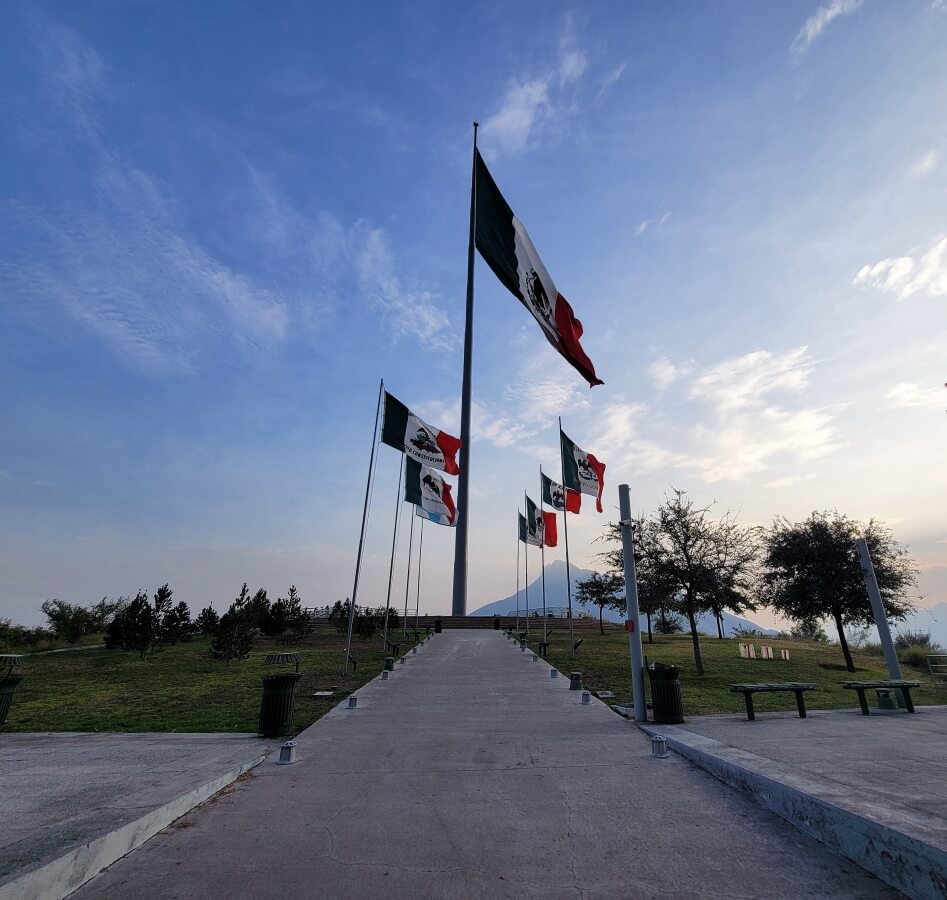 An observation deck with several Mexican flags waving in the air.