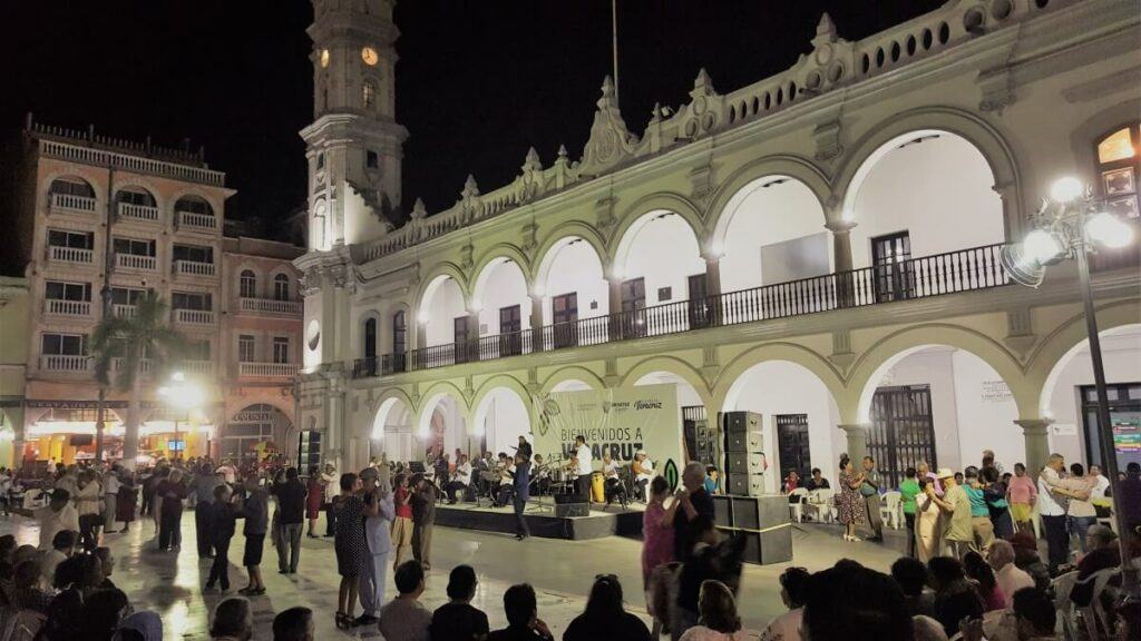 A group of people dancing at night.