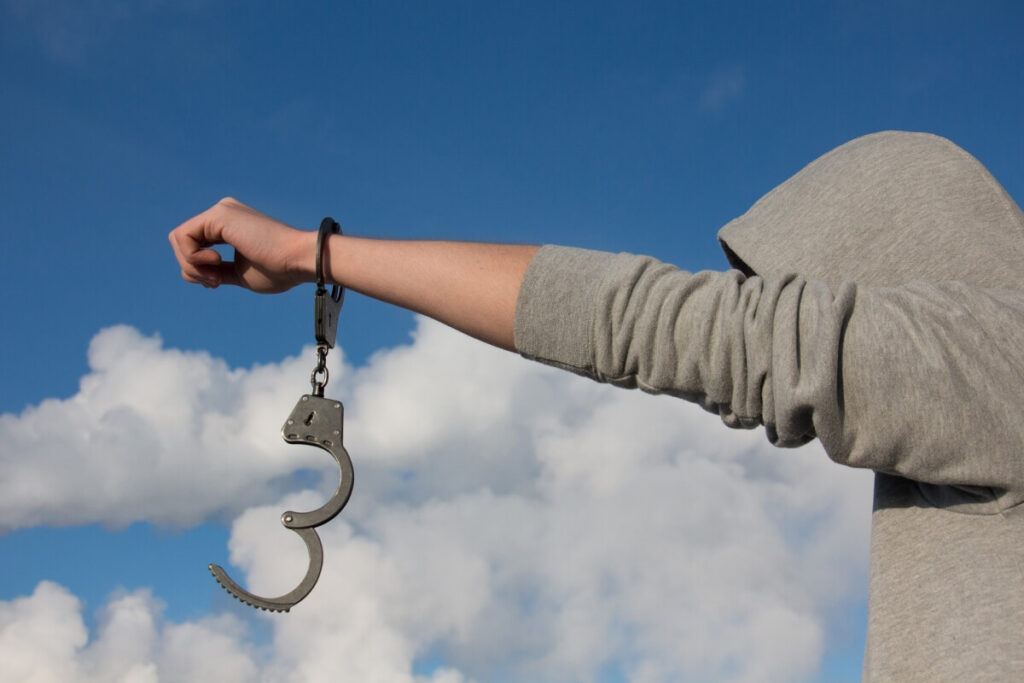 A man holding a handcuff.