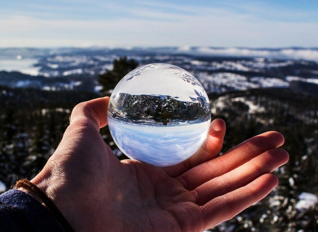 A hand holding a crystal ball.