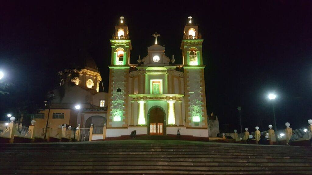 A church lit up in yellow colors.