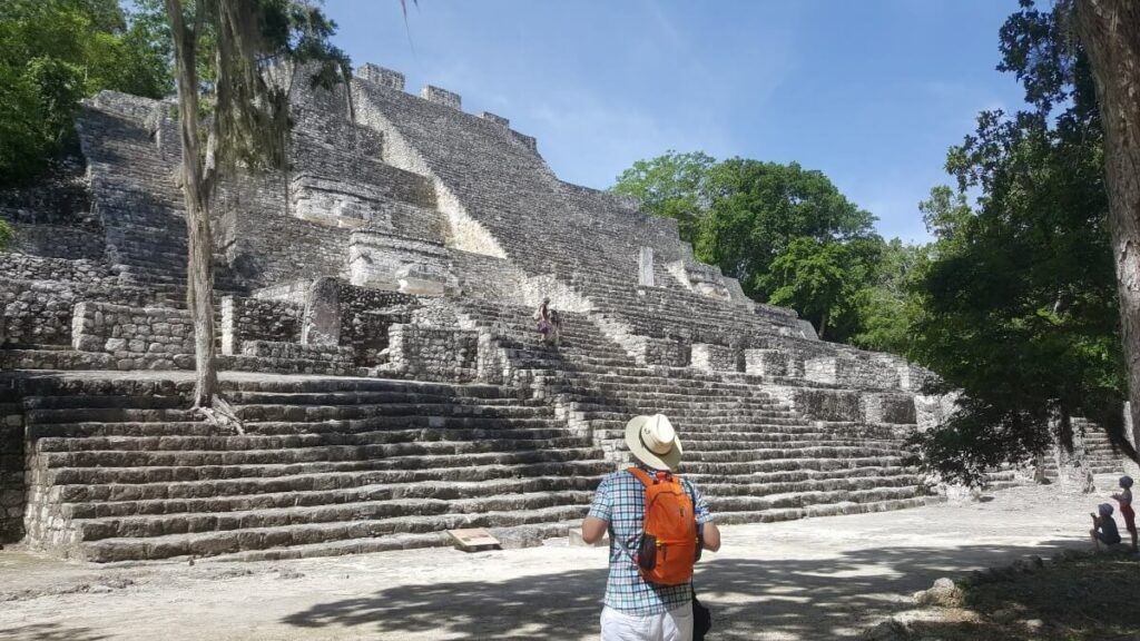 Young man at the base of a pyramid.