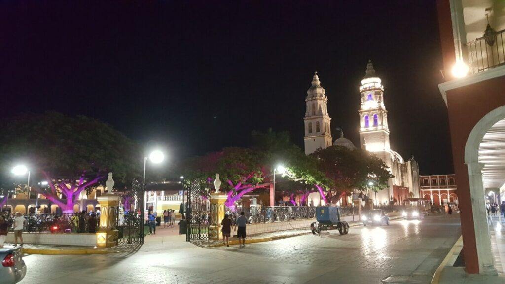 Plaza and church lit up at night.