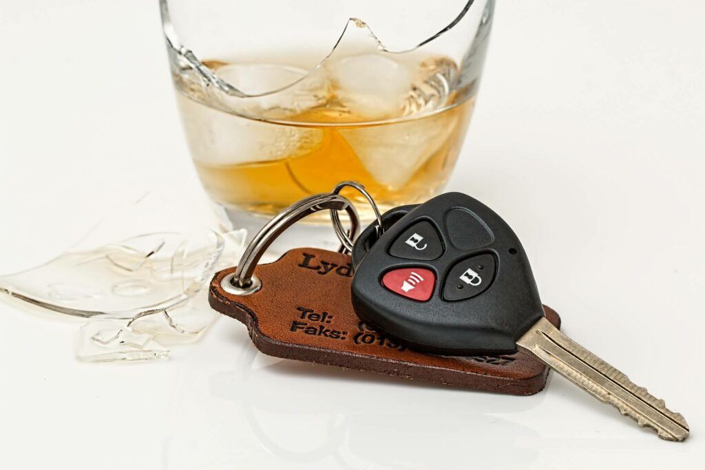 A glass of whiskey and some car keys.