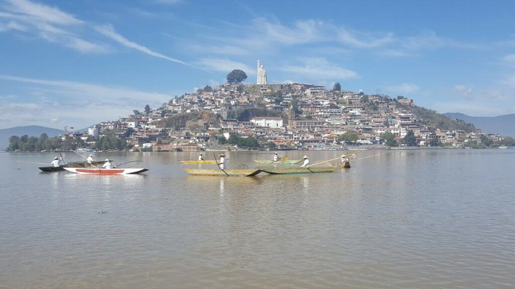 An island with a group of fishermen using butterfly-shaped nets.