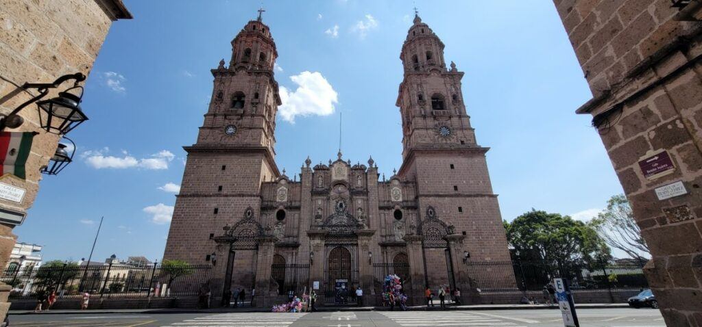 Facade of a pink stone cathedral.