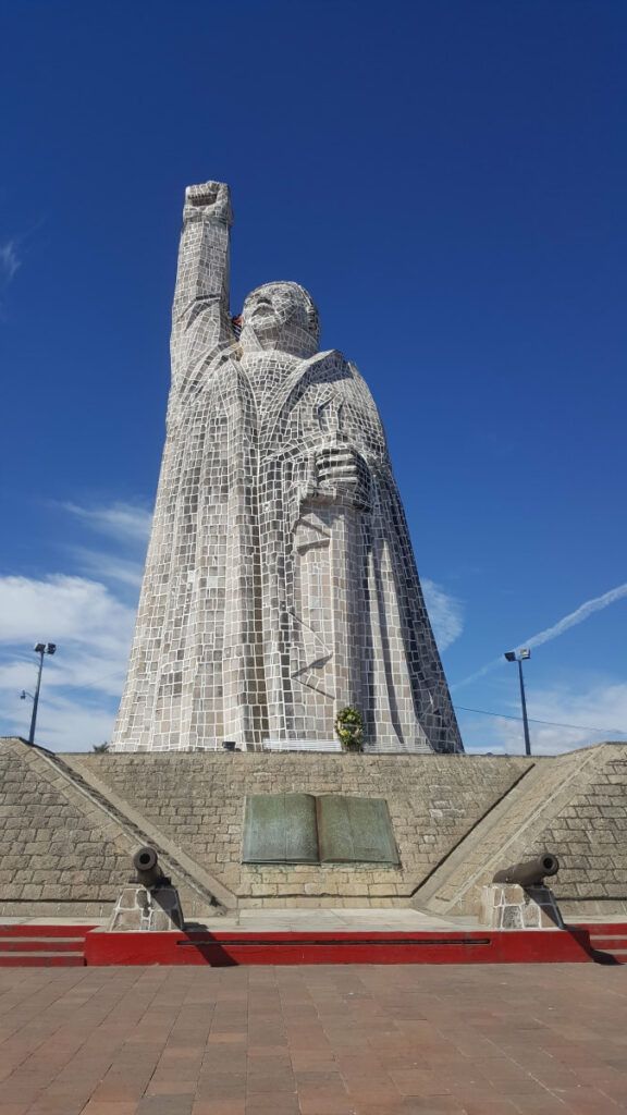 A giant statue holding its fist up.