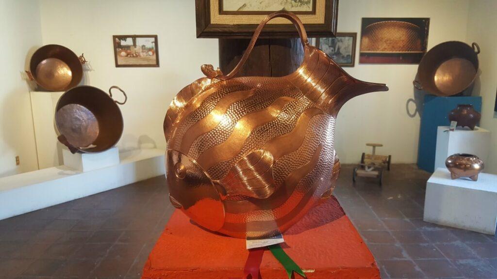 A giant vase and other items made of copper.