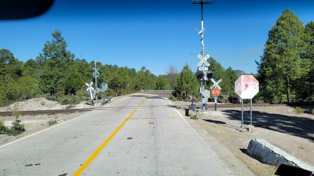 A car stopped at a railroad crossing.