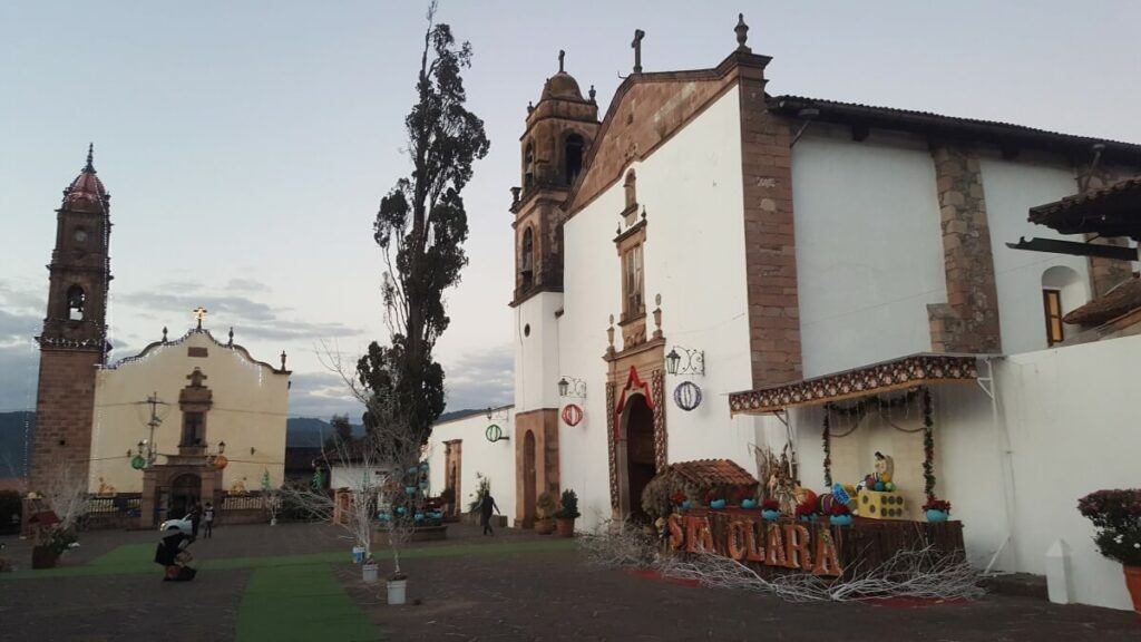 An old white church and a patio in front of it.