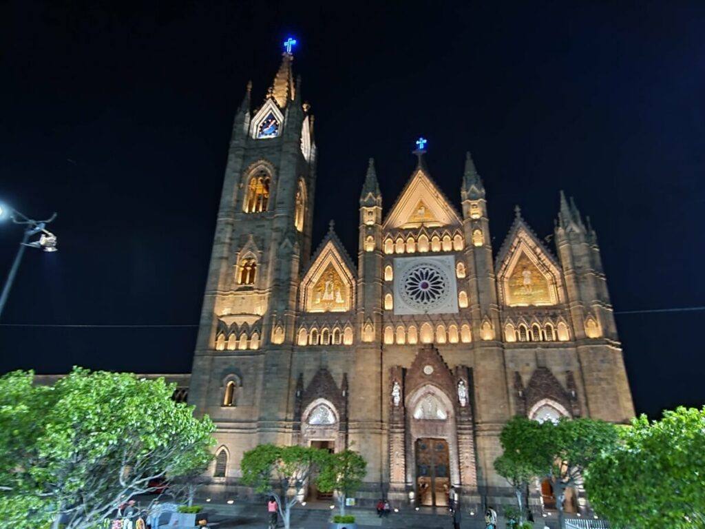 A neo-Gothic temple lit up at night.