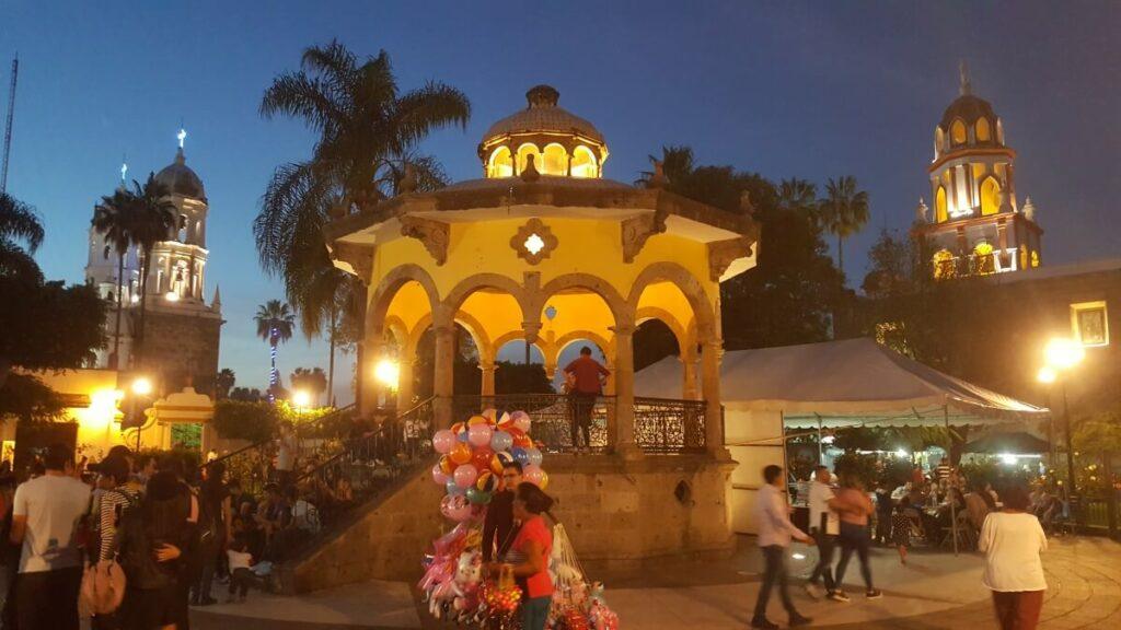 Main square of a small town lit up at night.